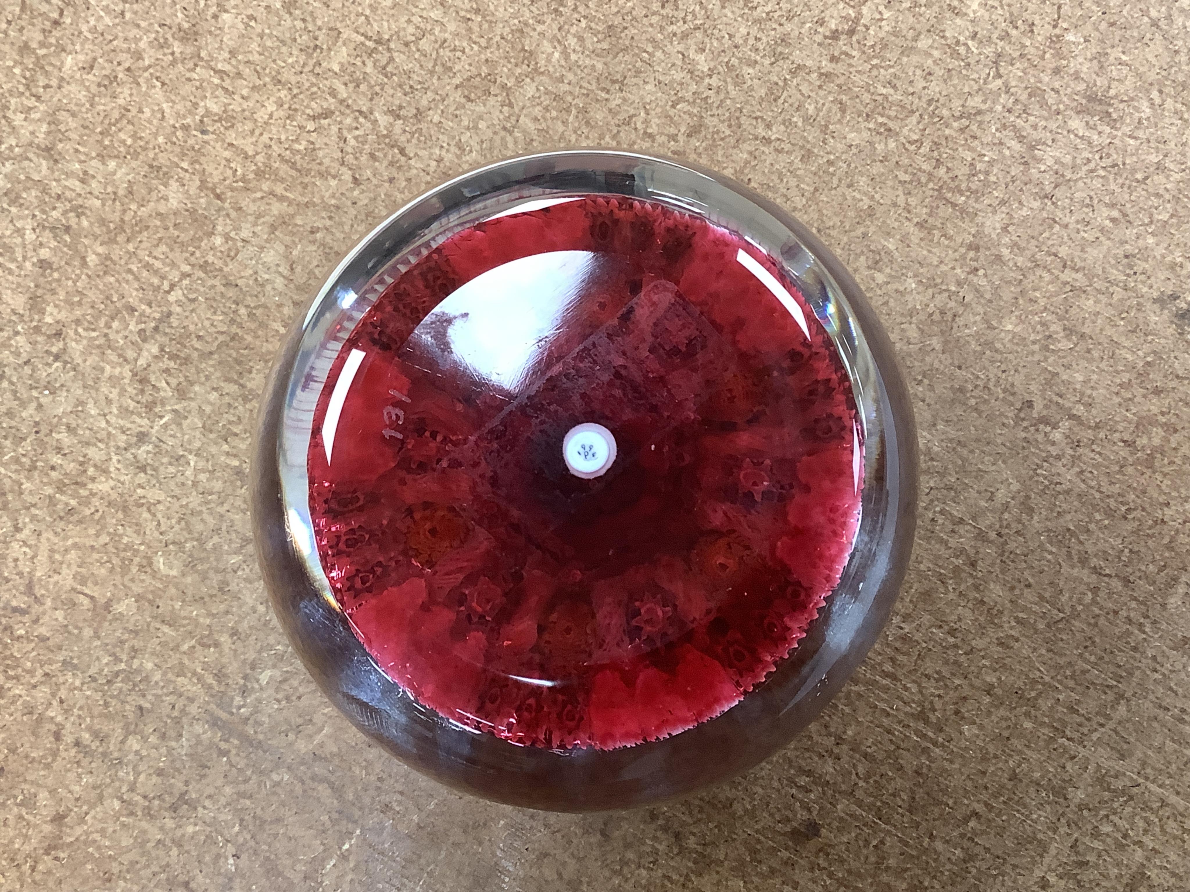 Two boxed Perthshire glass paperweights, the first faceted with latticino twists and complex canes, the second close packed millefiori paperweight, 62/400